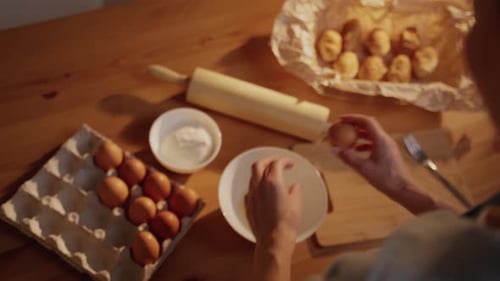 Adult Cracking Eggs for Baking at Home
