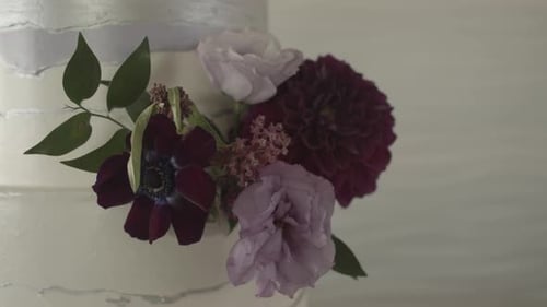 Decorated Wedding Cake With White Frosting and Flowers