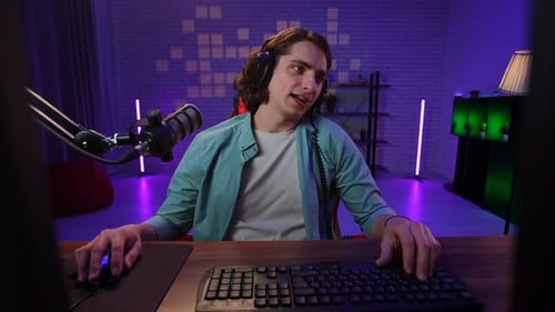 Young Man Using Computer for Streaming or Podcast