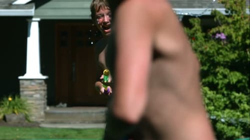 Boy Laughing, Shooting Water Gun at Friend Outdoors