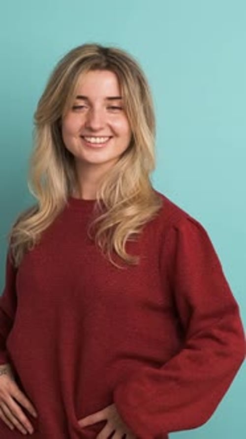 Happy Woman Shaking Head in Blue Studio