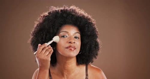 Face, foundation and makeup brush with black woman in studio for application of makeover cosmetics