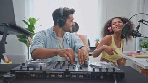 Group of diverse stylish audio producer working in music record studio.