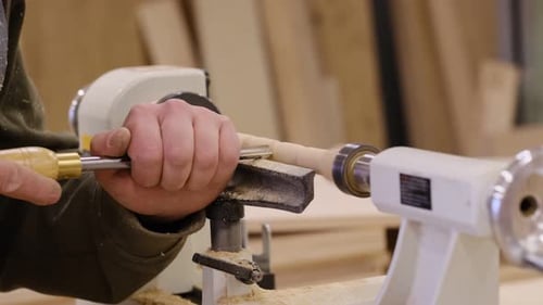 Close Up Carpenter at Workshop Polishes Wooden Board with a Electric Orbital Sander Woodwork and
