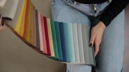 Women Selecting Colorful Fabric Samples in Interior Design Studio