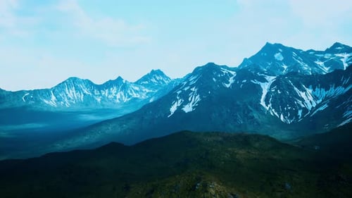 Sunny Landscape with Views of Snowcapped Mountains and Meadow