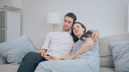 Affectionate Couple Relaxing Together on Couch at Home