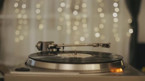 Hands Placing a Record on a Turntable