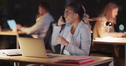 Joyful Afroamerican Female Office Manager Talking on the Phone Finishing Call Working in Late Office
