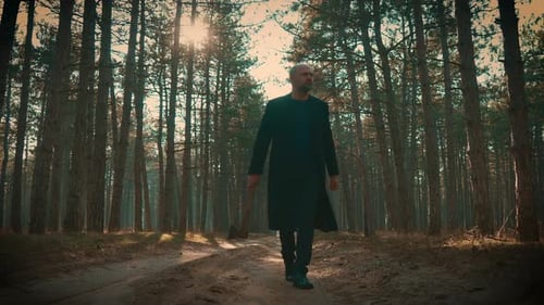 Killer in Forest Man with Axe in Hands Spooky Murderer Slowly Walking Through Mist Forest