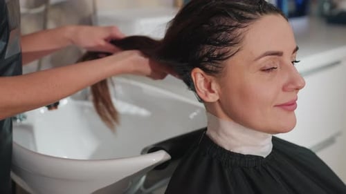 Woman getting her hair washed in hair salon