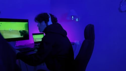 Gamers Celebrate Victory in Blue Lit Room