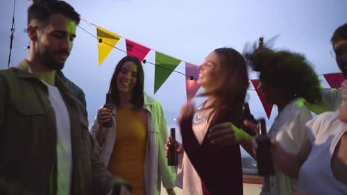Group of Multiracial Friends in a Terrace Dancing and Having Fun Together