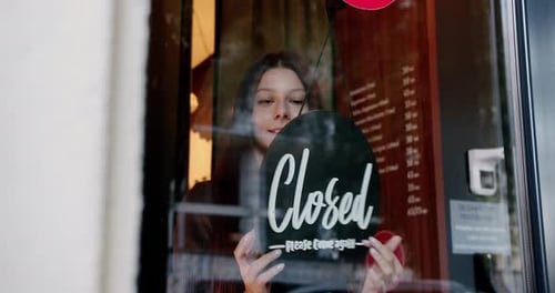 Happy Young Waitress Opening Restaurant
