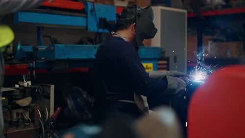 Welder Welding Steel Working in Factory Metal Parts Welding