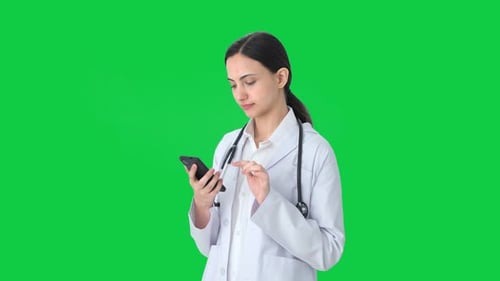 Indian female doctor using phone Green screen