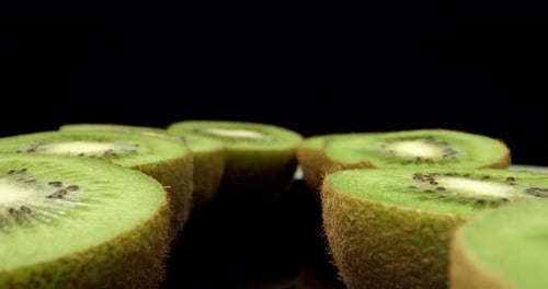 Freshly picked green kiwi fruit cut in half super close up shoot fly over laowa k4 high quallity