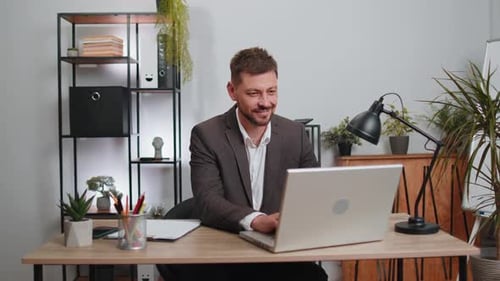 Businessman Freelancer Enters Office Workplace Working on Laptop Computer Sends Online Messages