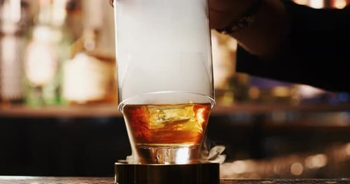 Close up of a professional bartender is preparing an alcoholic cocktail with professional crystal