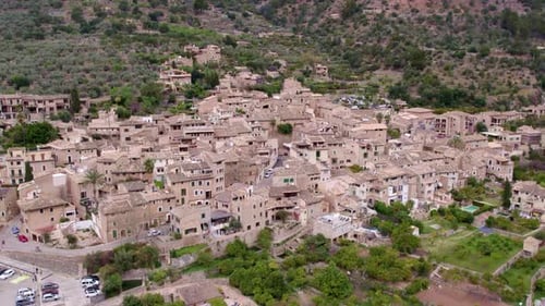 Aerial view of rustic town in mountain landscape, Spain.