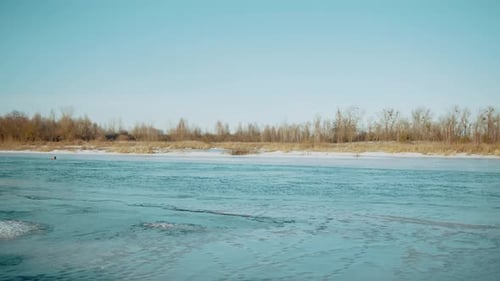 Beautiful Winter Landscape on a Sunny Day and a View of the Rapid Flow of the River Between the