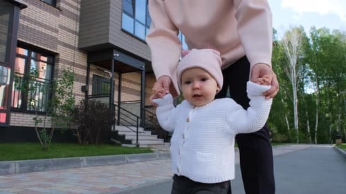 Adorable Baby Learning to Walk with Mother