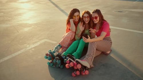 Women in Quad Roller Skates Filming Fun Video on Mobile