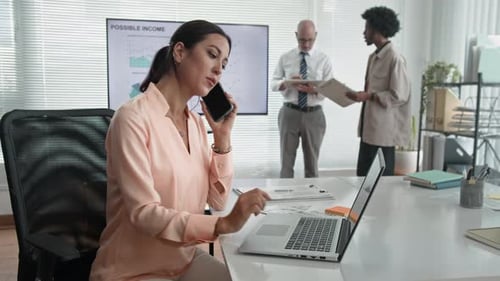 Consulting Manager Having Phone Talk at Office Desk