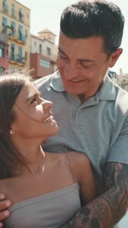 Cheerful Father and Daughter Embrace Outdoors in City