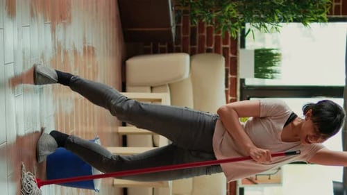 Woman Dancing While Cleaning Apartment With Mop