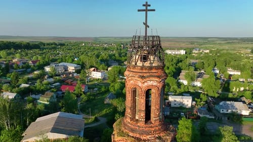 Close up aerial view of a tall, weathered brick bell tower
