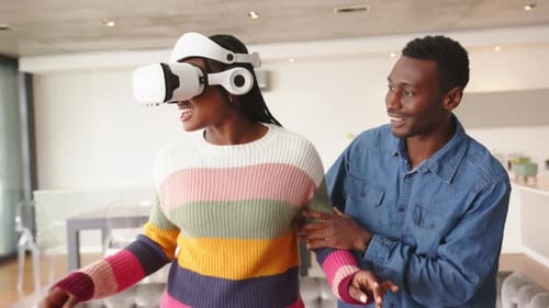 Woman Experiencing Virtual Reality at Home with Friend