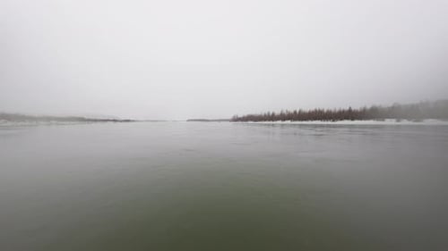 Winter's Gentle Touch Inspires Wonder as the First Snow Blankets the Tranquil River Scene