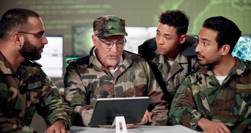 Soldiers Looking at Tablet in Military Workplace