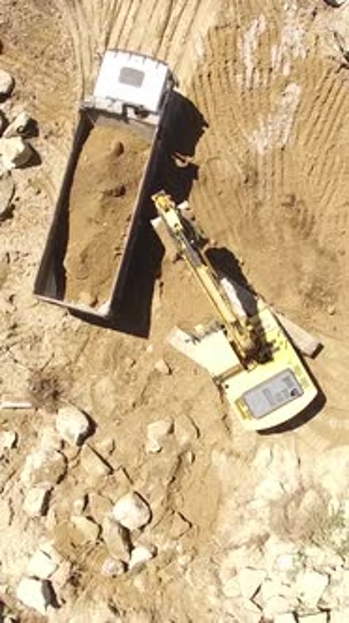 Vertical Video of Excavator Working with Truck