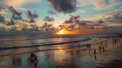 Sunset at Brawa Beach Bali with Crowds Enjoying the Ocean and Reflections