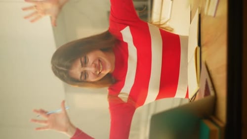Smiling Woman Writes at Desk Indoors