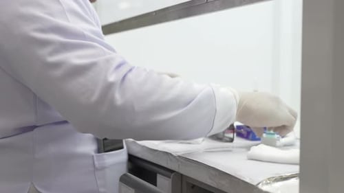 Scientist Working in Lab with Microscope Slides