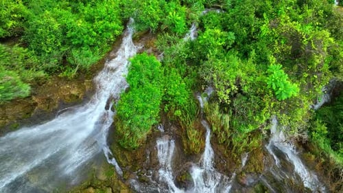Beautiful waterfall in a tropical forest by aerial view from a drone.