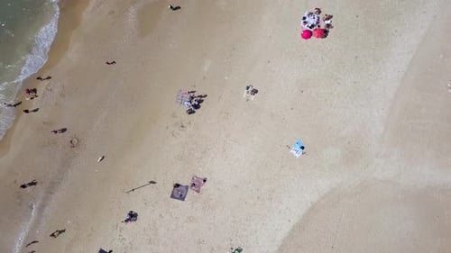 Mediterranean beach during summer with people in the water
