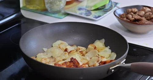 Potatoes Frying in a Pan on Stove Top