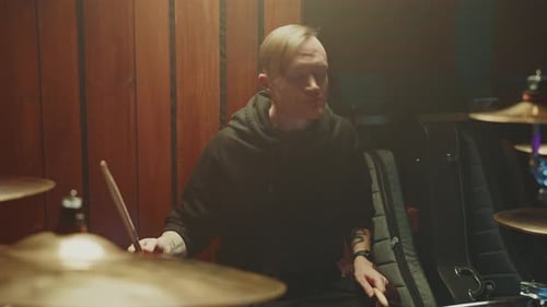 Drummer Performs Intense Solo in Dimly Lit Studio Session
