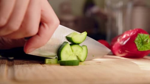 Top Down View Female Hands Cut Green Fresh Cucumber on Board Closeup