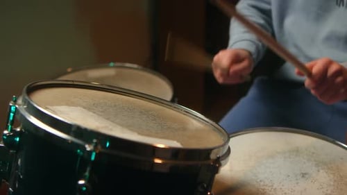 Musician Playing Snare Drum with Drumsticks in Recording Studio