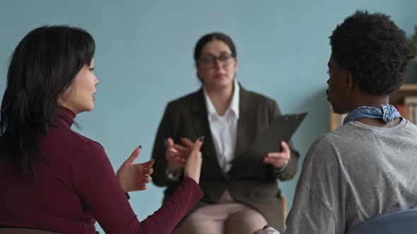 Female Counselor Defusing Conflict between Diverse Teens Having ...