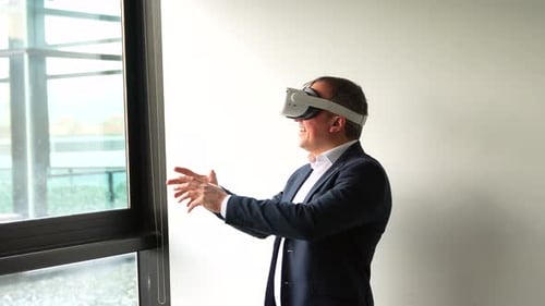 Man Uses VR Headset in Bright Office