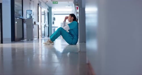 Nurse, stress and sad on floor for hospital mistake, healthcare fail or bad news of clinic death