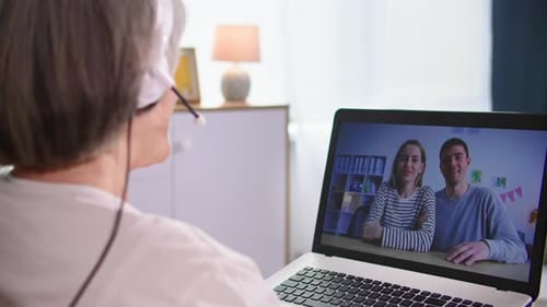 Senior Woman Video Calling Couple on Laptop