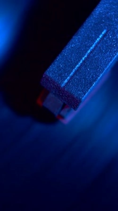 Abstract Close Up of Dark Sanding Block in Blue Light