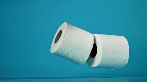 Toilet Paper Rolls Falling on Blue Background